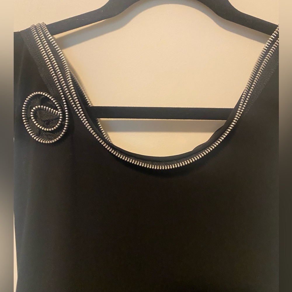Funky little black dress embellished with zippers.